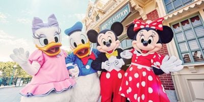 Daisy Duck, Donald Duck, Mickey Mouse and Minnie Mouse in front of the Hong Kong Disneyland train station