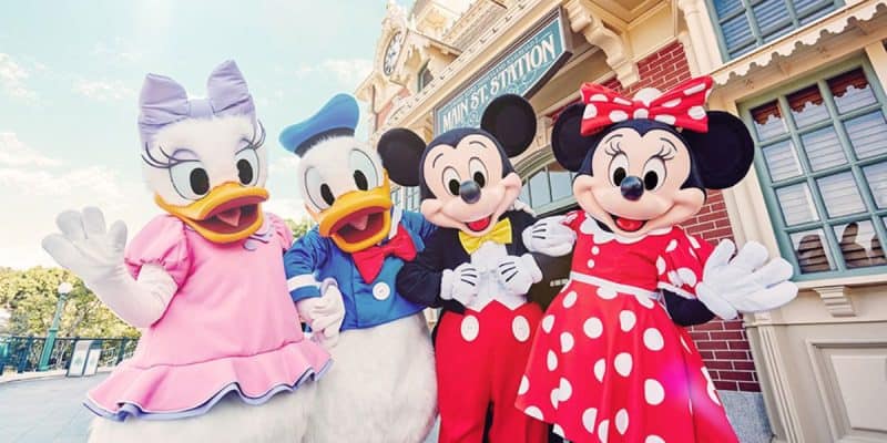 Daisy Duck, Donald Duck, Mickey Mouse and Minnie Mouse in front of the Hong Kong Disneyland train station