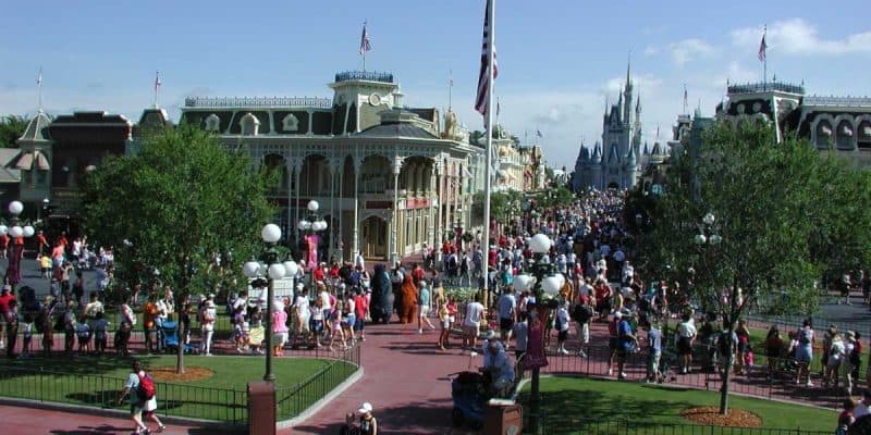 A large crowd walks along Main Street, U.S.A. at the Magic Kingdom.