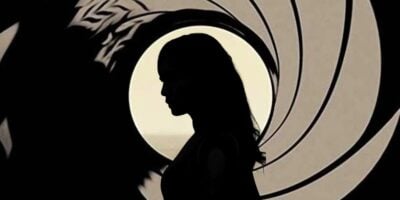 Mixed image: A silhouette of Gemma Chan from 'Eternals' in the foreground and the James Bond logo behind her
