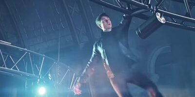 James Bond hanging from a structure in "007 First Light"