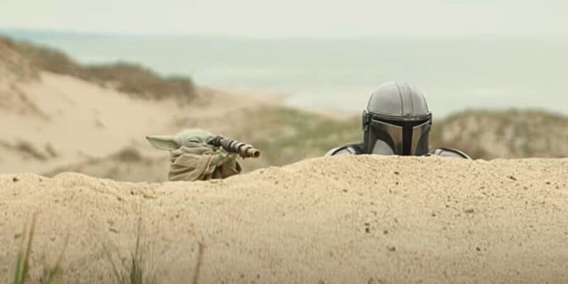 Grogu and Din Djarin spying over a hill in 'The Mandalorian and Grogu' trailer