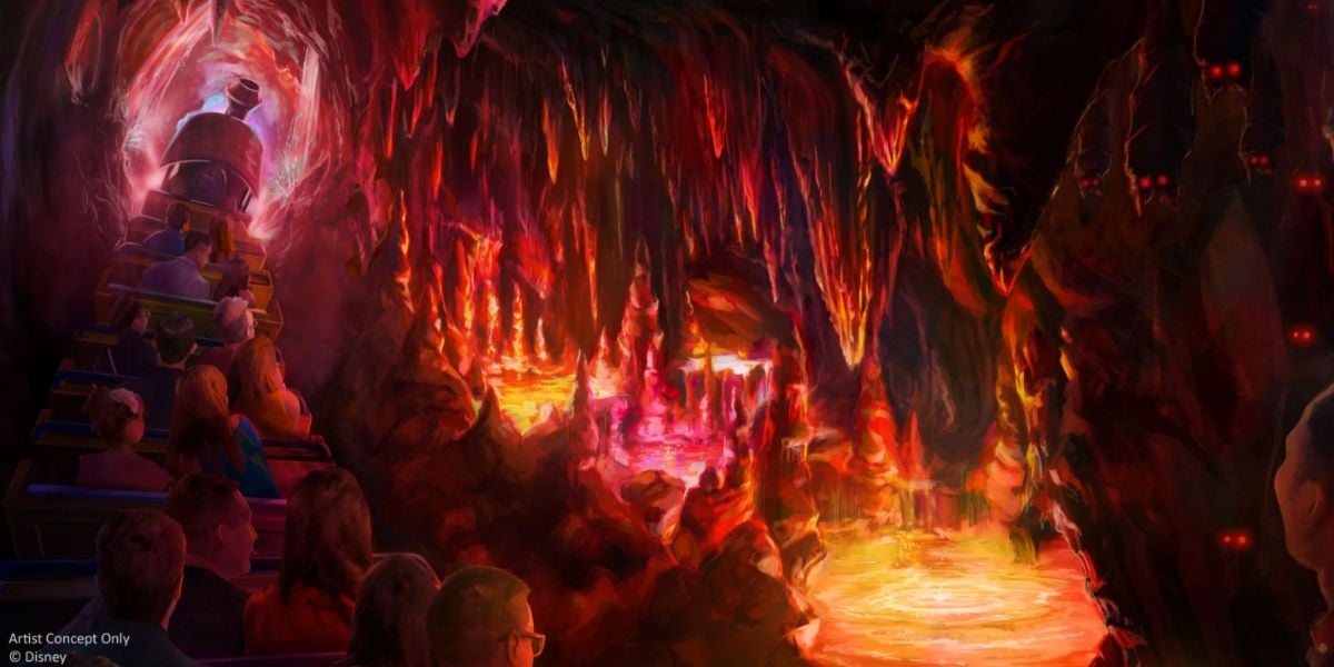A group of people ride a train through a glowing, colorful cave on Big Thunder Mountain, passing bright orange and yellow pools, jagged rock formations, and mysterious red eyes glowing in the darkness.