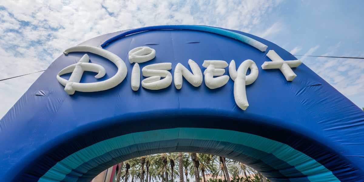 A large blue inflatable arch with the Disney+ logo.