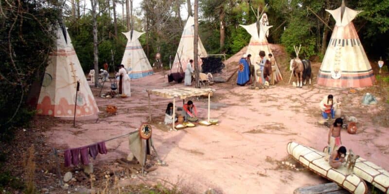 A recreated Native American village scene on the Walt Disney World Railroad path at Magic Kingdom Park.