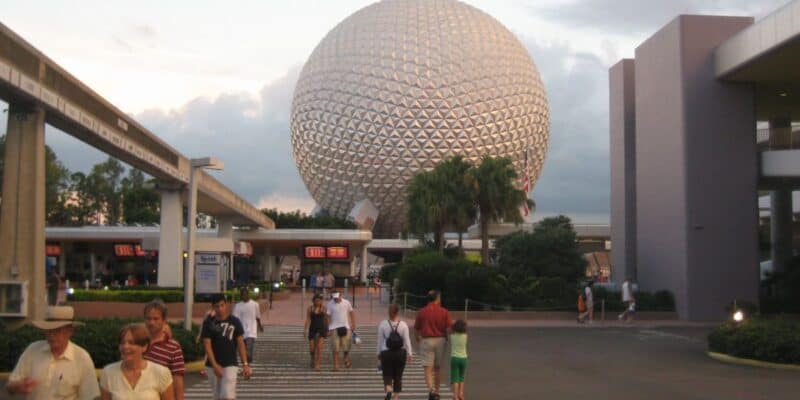 Visitors walking toward the main entrance to EPCOT, from the parking lot.