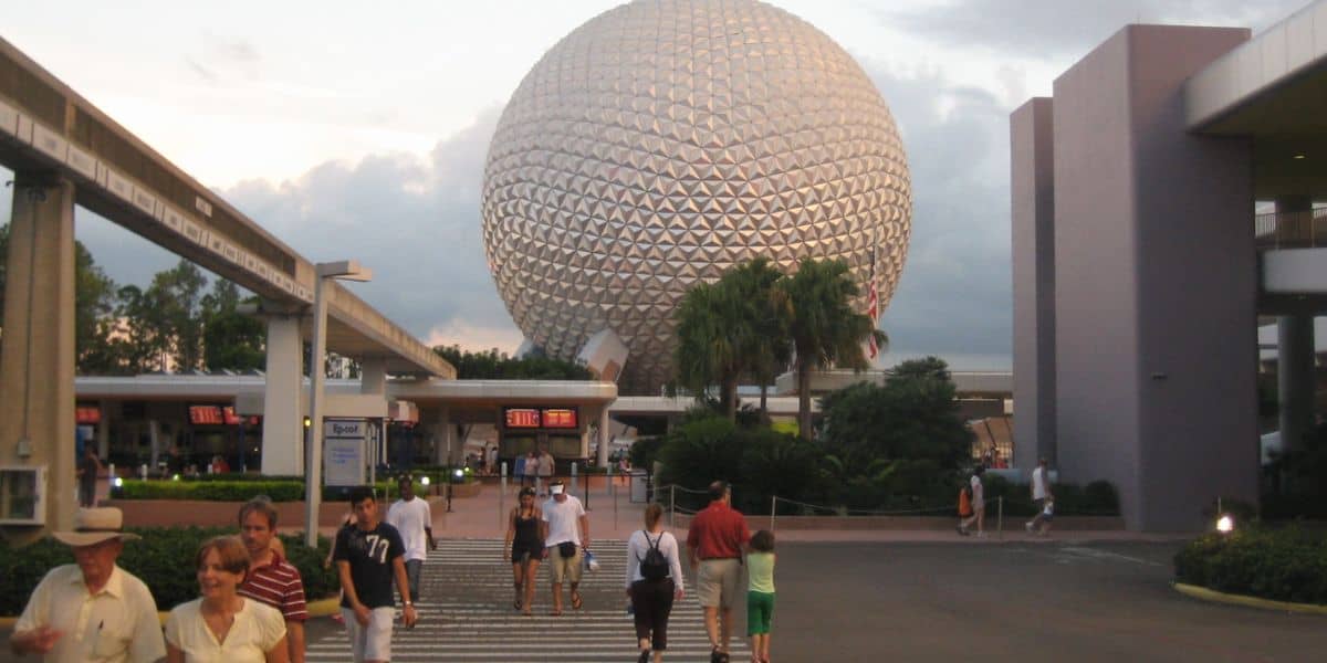 Visitors walking toward the main entrance to EPCOT, from the parking lot.