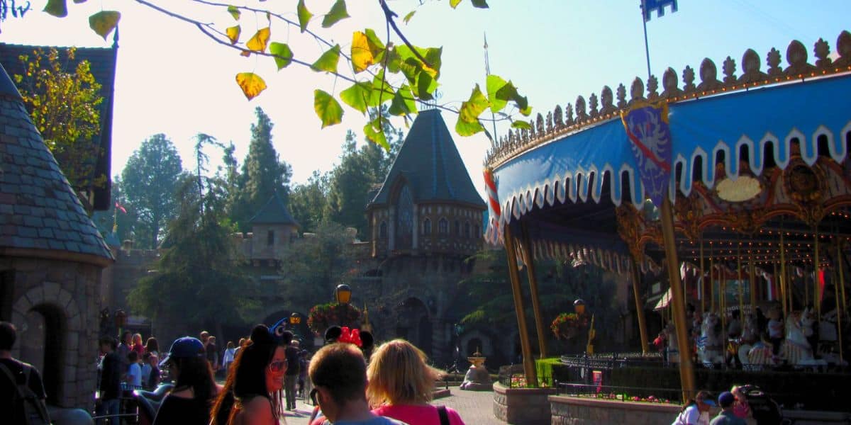 People walk through Fantasyland at Disneyland Park