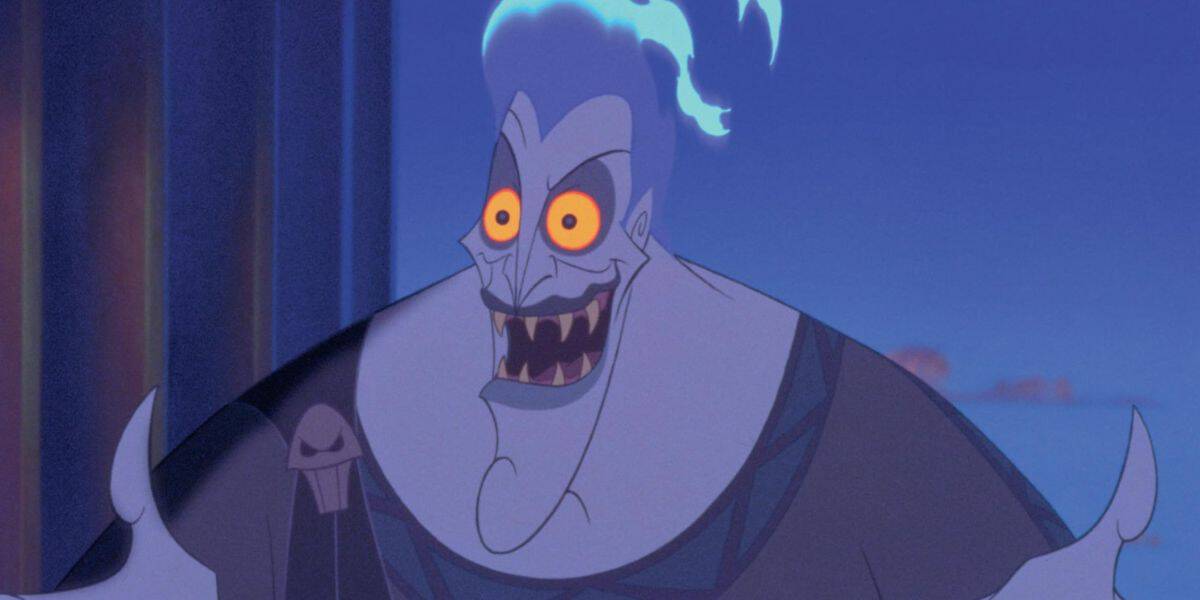 Animated villainous character with blue flaming hair, gray-blue skin, yellow eyes, and sharp teeth, grinning widely with an expressive face, set against a dark blue background.