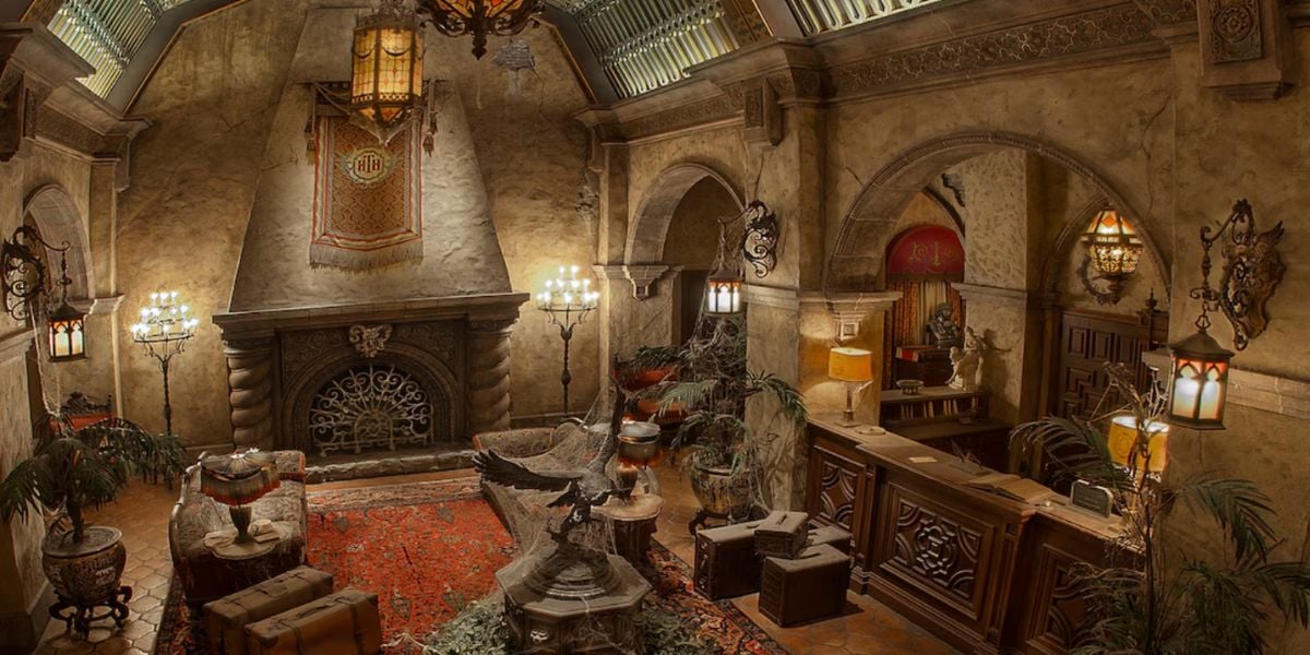 A lavish, old-fashioned hotel lobby with ornate chandeliers, antique furniture, and vintage suitcases brings a mysterious, abandoned vibe—reminiscent of the eerie Tower of Terror.
