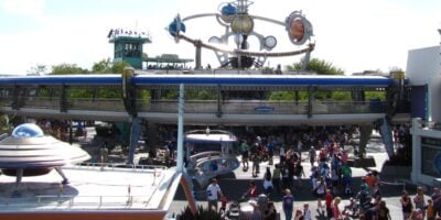Crowds of people walk in Tomorrowland at Magic Kingdom Park.