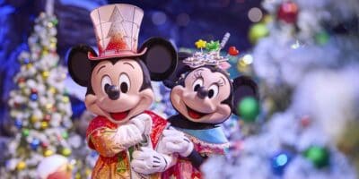 Mickey Mouse and Minnie Mouse dressed in festive holiday outfits at Disneyland Paris