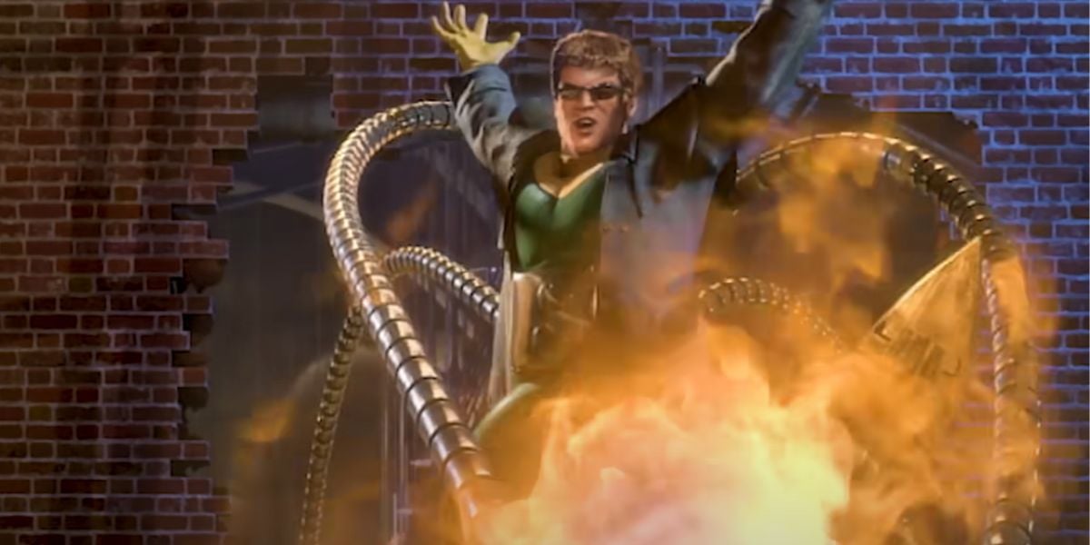 A man wearing dark goggles and a harness with four mechanical tentacles stands in front of a brick wall, arms raised, surrounded by flames and smoke—facing off against Spider-Man’s unseen challenge.