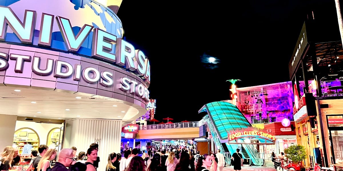 A universal crowd of people gathers outside of a building.