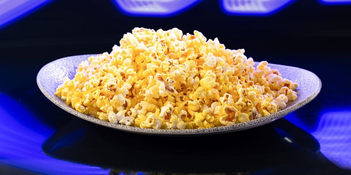 A large plate piled with buttered popcorn.
