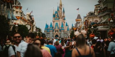 massive crowd at cinderella castle in disney world's magic kingdom park