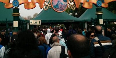 A crowd of people waits in line at a security checkpoint at Disneyland Paris Resort