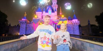 Mr. Beast and his fiance in front of Sleeping Beauty Castle at Disneyland theme park.
