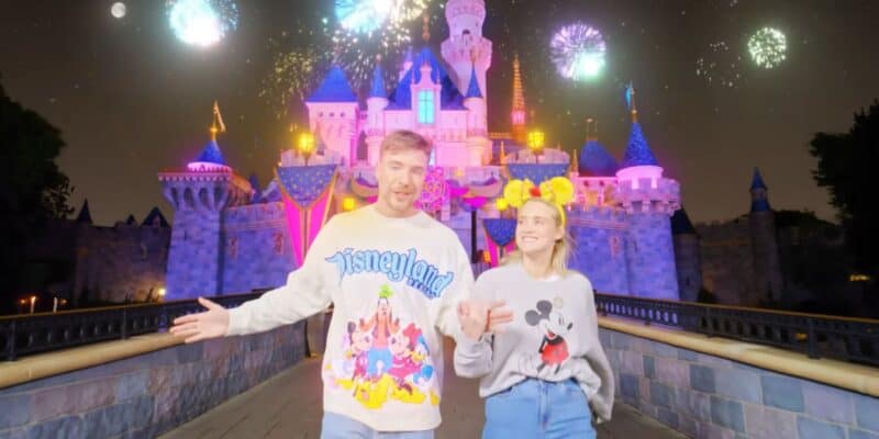Mr. Beast and his fiance in front of Sleeping Beauty Castle at Disneyland theme park.