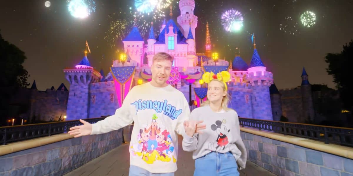 Mr. Beast and his fiance in front of Sleeping Beauty Castle at Disneyland theme park.