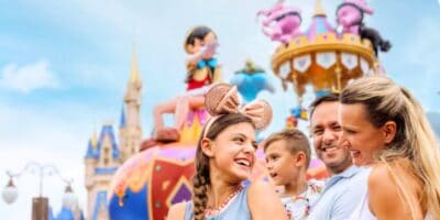 Family standing in front of the Festival of Fantasy parade at Magic Kingdom