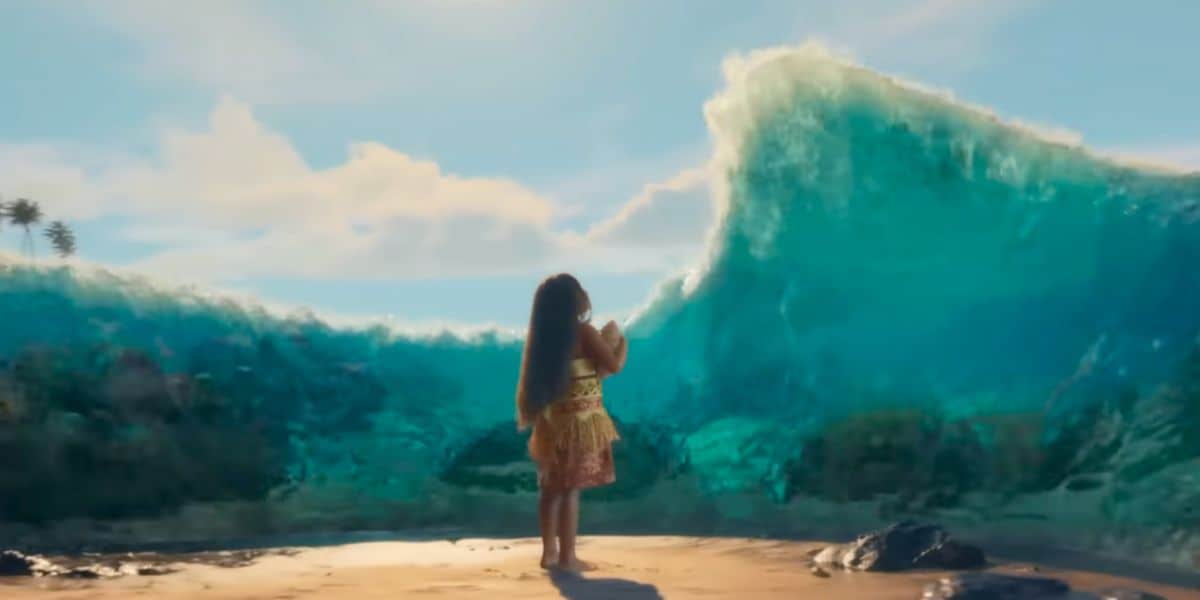 A girl with long dark hair stands on a sandy beach, Moana-like, facing a large wave that parts before her, revealing a path through the ocean. The sky is bright with scattered clouds.