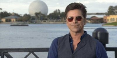 John Stamos at the World Showcase in EPCOT with Spaceship Earth in the background