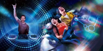 Guests ride Space Fantasy – The Ride: CLUB ZEDD REMIX in a promotional image while Zedd DJs next to them