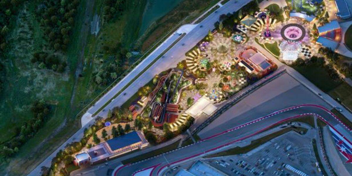 Aerial night view of the illuminated amusement park beside the racetrack, where coaster riders recently awaited rescue after a 911 call.