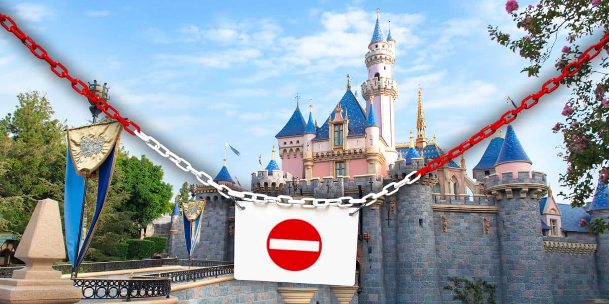 Sleeping Beauty Castle at Disneyland blocked by a no entry sign and chain, signaling restricted access for park guests.