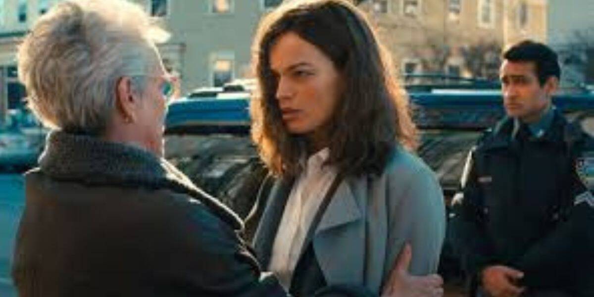 A grandmother and her granddaughter link arms as a security officer stands nearby on Main Street, USA at Magic Kingdom.