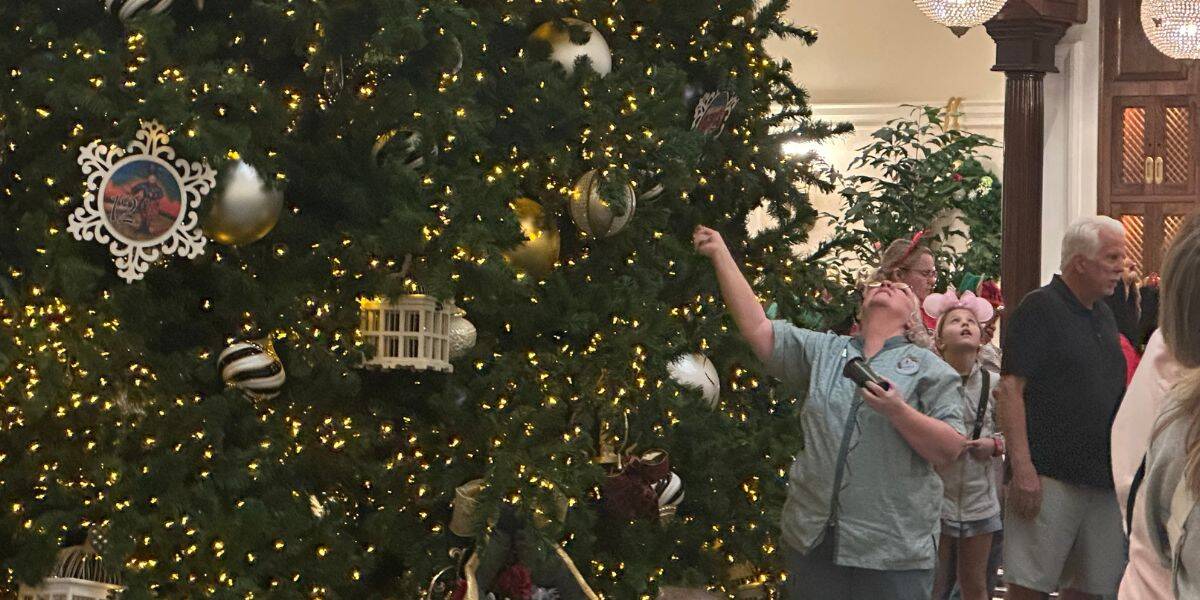 Guests gather at Disney’s Grand Floridian to marvel at a stunning Christmas tree as Cast Members add extra Disney holiday magic.