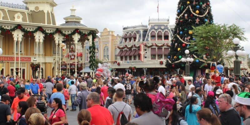 Main Street Christmas tree in Disney World surrounded by massive crowds