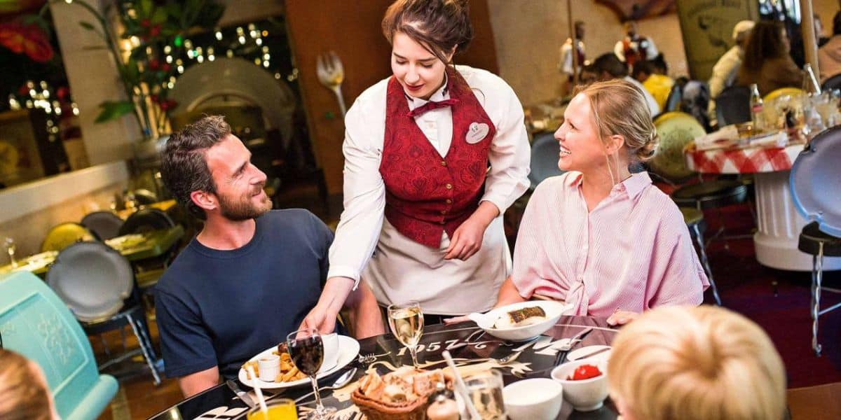 A waitress serves a family at Bistrot Chez Rémy