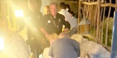 Firefighters carrying a teenager in a wheelchair away from the Matterhorn Bobsleds