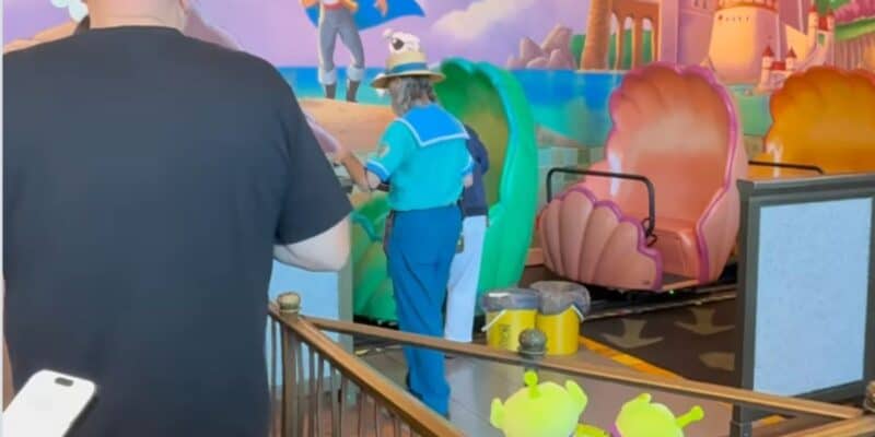 A Disney World cast member cleans up a Little Mermaid ride vehicle