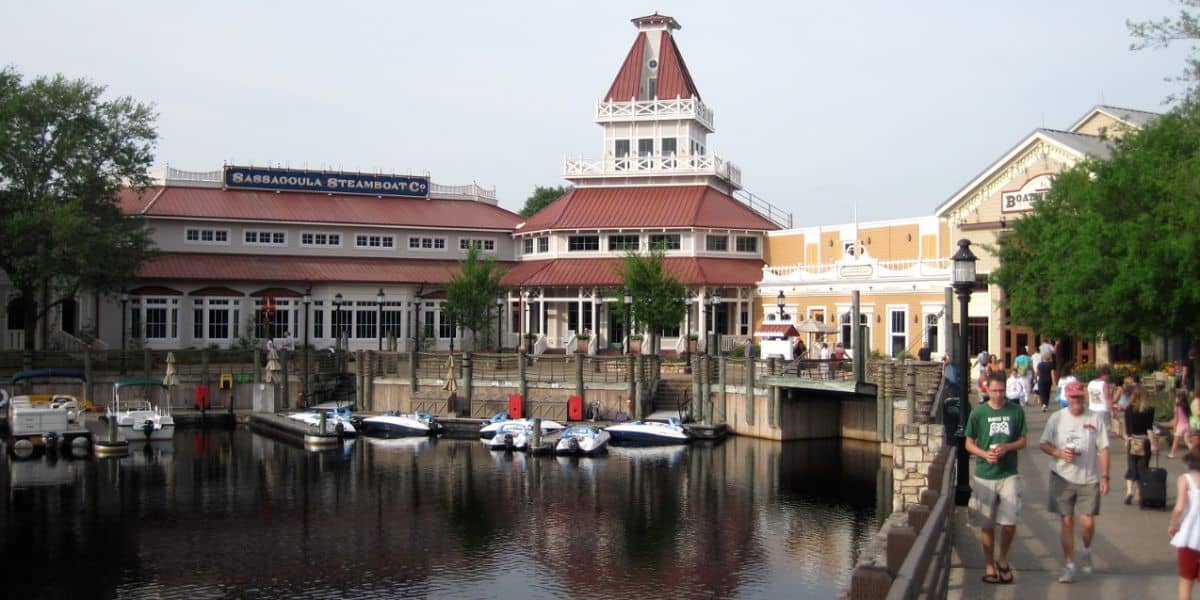 Guests stroll by the Sassagoula Steamboat Co. building at Disney's Port Orleans Resort - Riverside