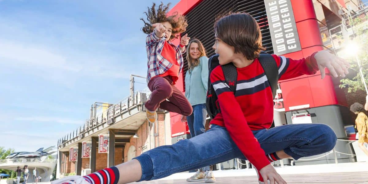 Guests pose outside the Spider-Man ride at Walt Disney Studios Park