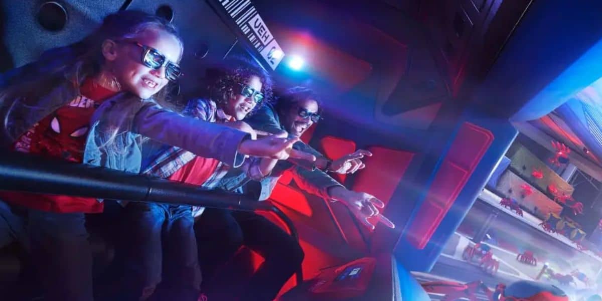 Guests wearing 3D glasses and shooting webs on Spider-Man W.E.B. Adventure at Disneyland Paris