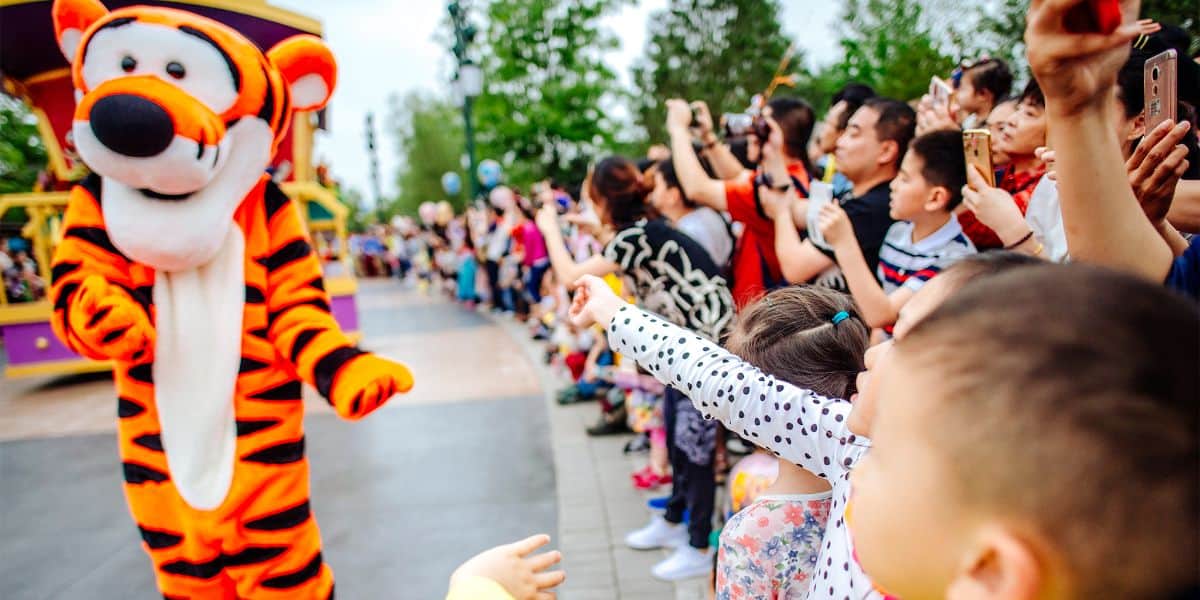 Guests wave at Tigger on the Shanghai Disneyland parade route