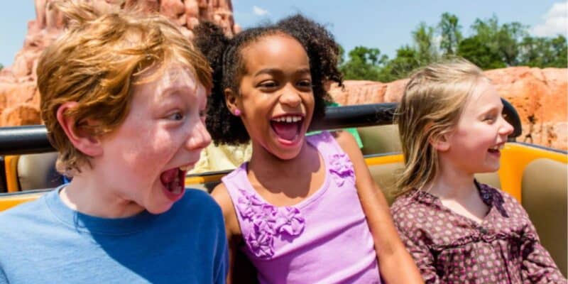 three younger guests ride Big Thunder Mountain in Disney World's Magic Kingdom park