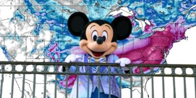 Mickey Mouse presents a chilly weather forecast in front of a U.S. map at Disney World, delighting travel park guests as a storm warning strikes half the country.