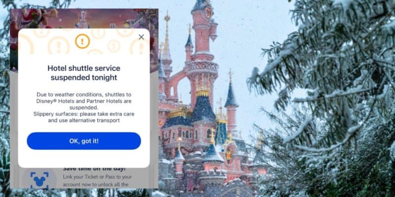 Sleeping Beauty Castle covered in snow with on-screen alert: hotel shuttle temporarily paused due to wintry weather conditions.