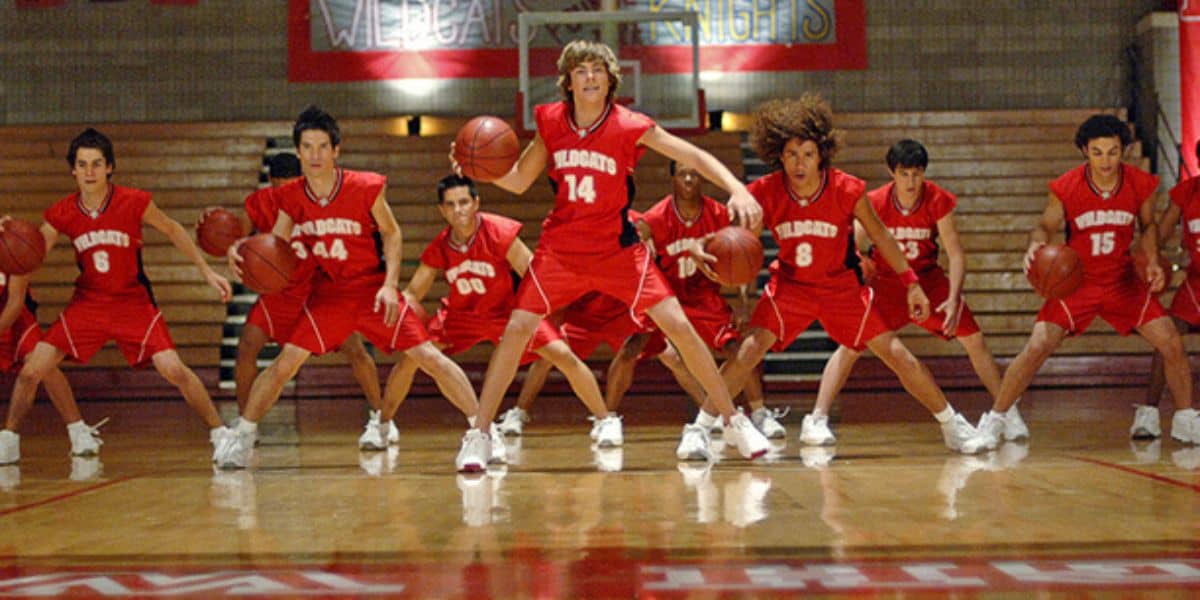 A team of athletes in matching red uniforms wow the crowd with synchronized dribbling on the indoor court at ESPN Wide World of Sports.
