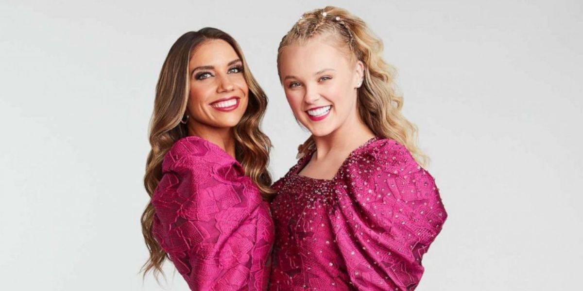 Guests dressed in matching pink dresses, smiling together in true Jojo Siwa fashion, ready for a fun-filled theme park day.