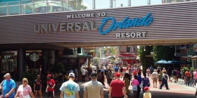 Guests stream beneath the iconic "Welcome to Universal Orlando Resort" archway in Universal CityWalk