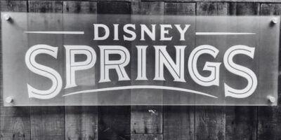 A black-and-white photo of a Disney Springs sign.