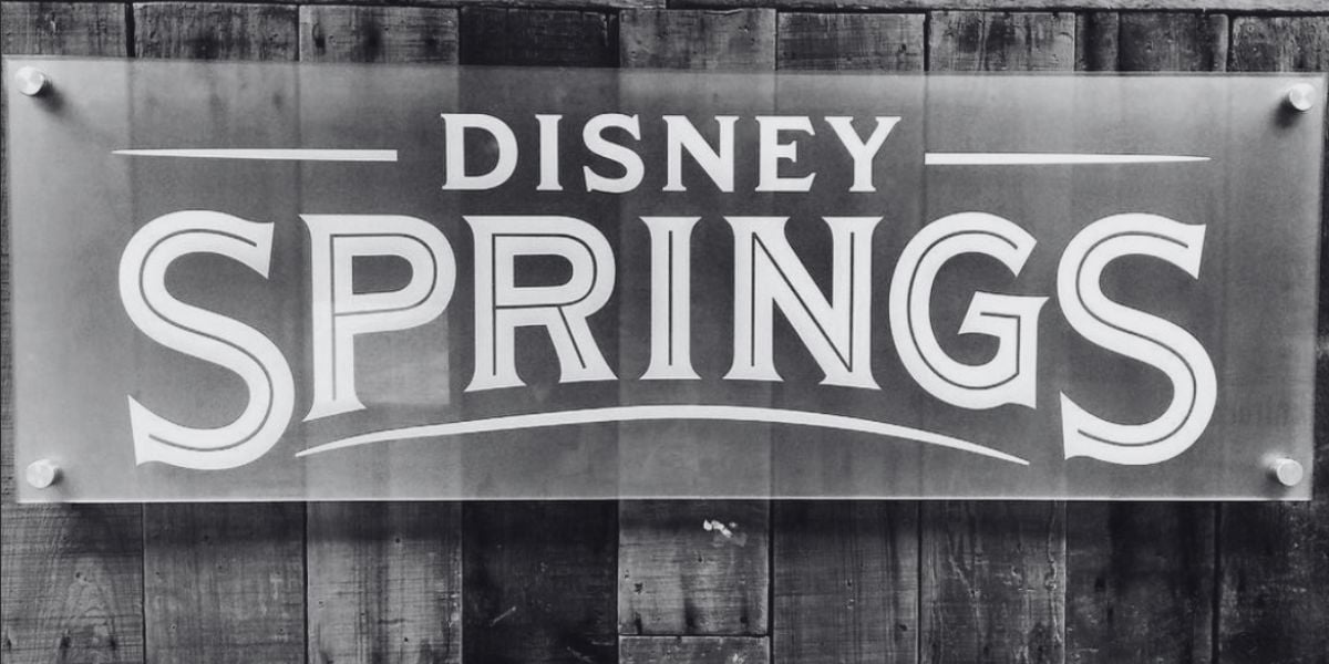 A black-and-white photo of a Disney Springs sign.