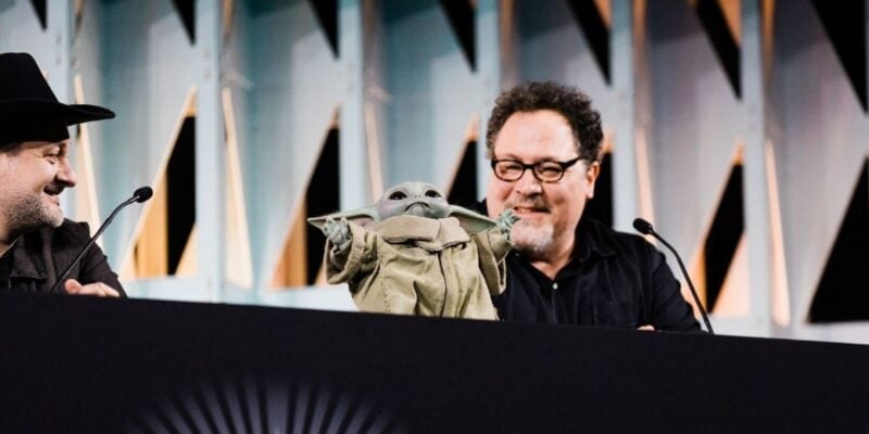 Jon Favreau with Grogu on a panel