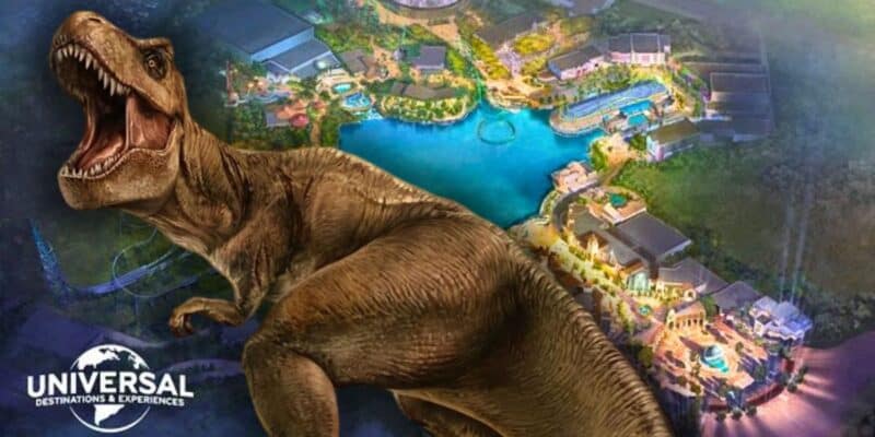 The fierce Jurassic Park T. rex roars in front of a colorful Universal Studios theme park map with the Universal logo nearby. Universal Bedford, United Kingdom.